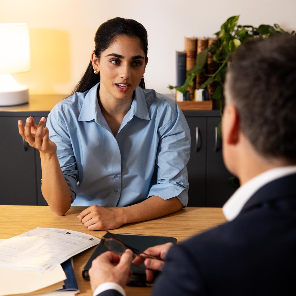 A young woman is talking to an man, who appears to be a mentor or teacher.